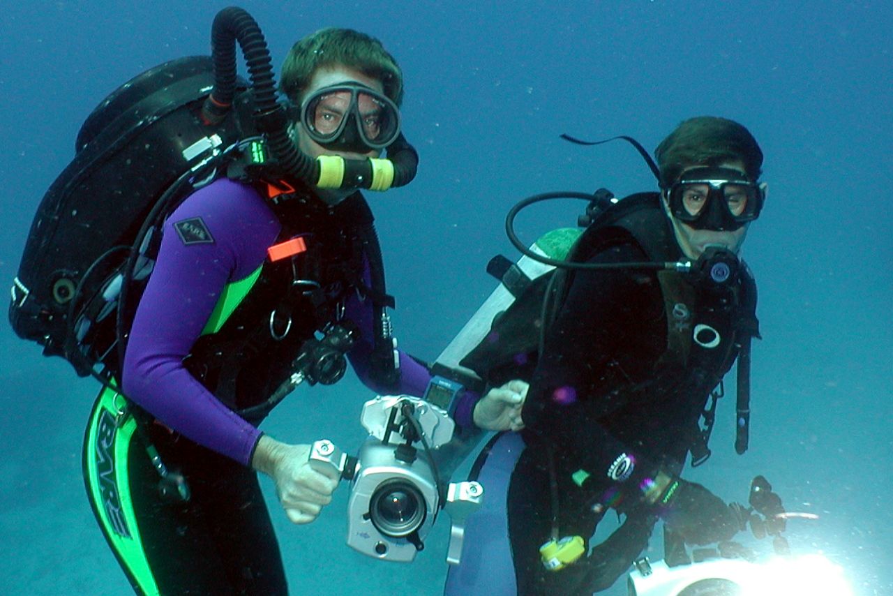 NAI'A founder Rob Barrel learns to use a rebreather from Avi Klapfer of the Undersea Hunter fleet during IMAX Coral Reef Adventure filming