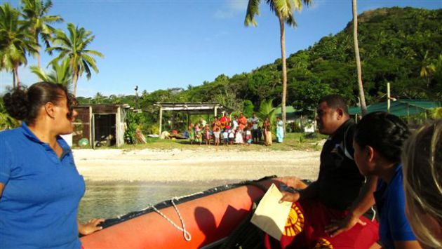 Suli and the skiff ride for the village visit. By Ron