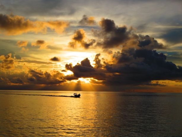 Skiff at sunset - by Jan