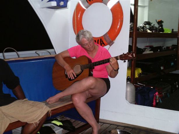 Debbie letting loose on the guitar at the crew carva party. By Heather